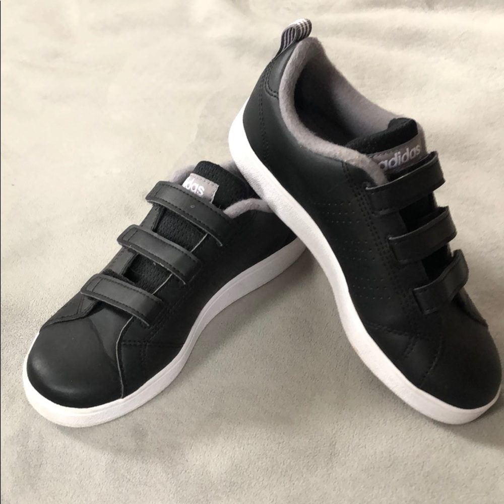 Boy’s black Adidas sneakers